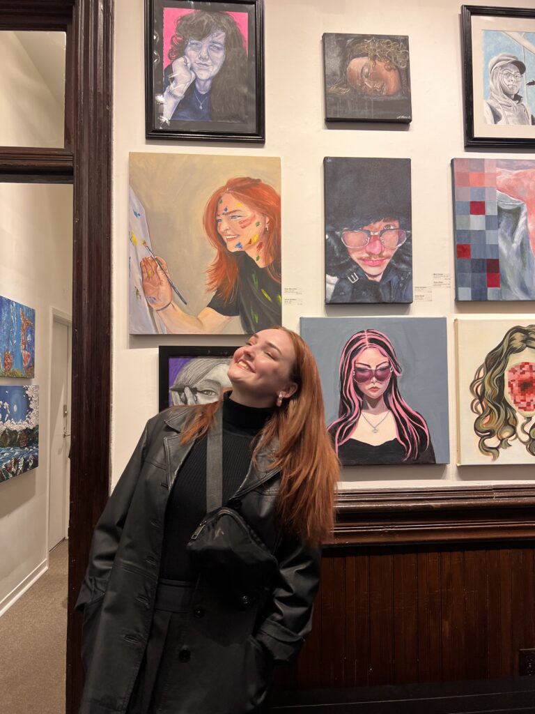 lillian looking at her painting in the Station Gallery